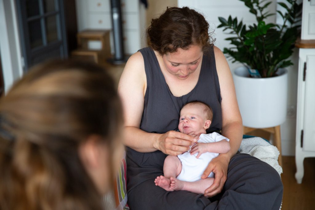 Séance d’accompagnement périnatal, Valentine tenant un nourrisson dans ses bras devant un parent